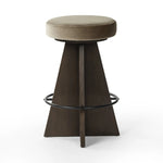 Featuring Damon Sapphire Khaki  Swivel Bar + Counter Stool by Four Hands at Amethyst Home. Large angular panels merge to form a geometrically inspired base in this modern counter stool. The circle metal ring around the base serves as a footrest, while the round upholstered cushion provides comfortable seating. The 360-degree swivel function adds versati. Amethyst Home provides interior design, new home construction design consulting, vintage area rugs, and lighting in the Winter Garden metro area.