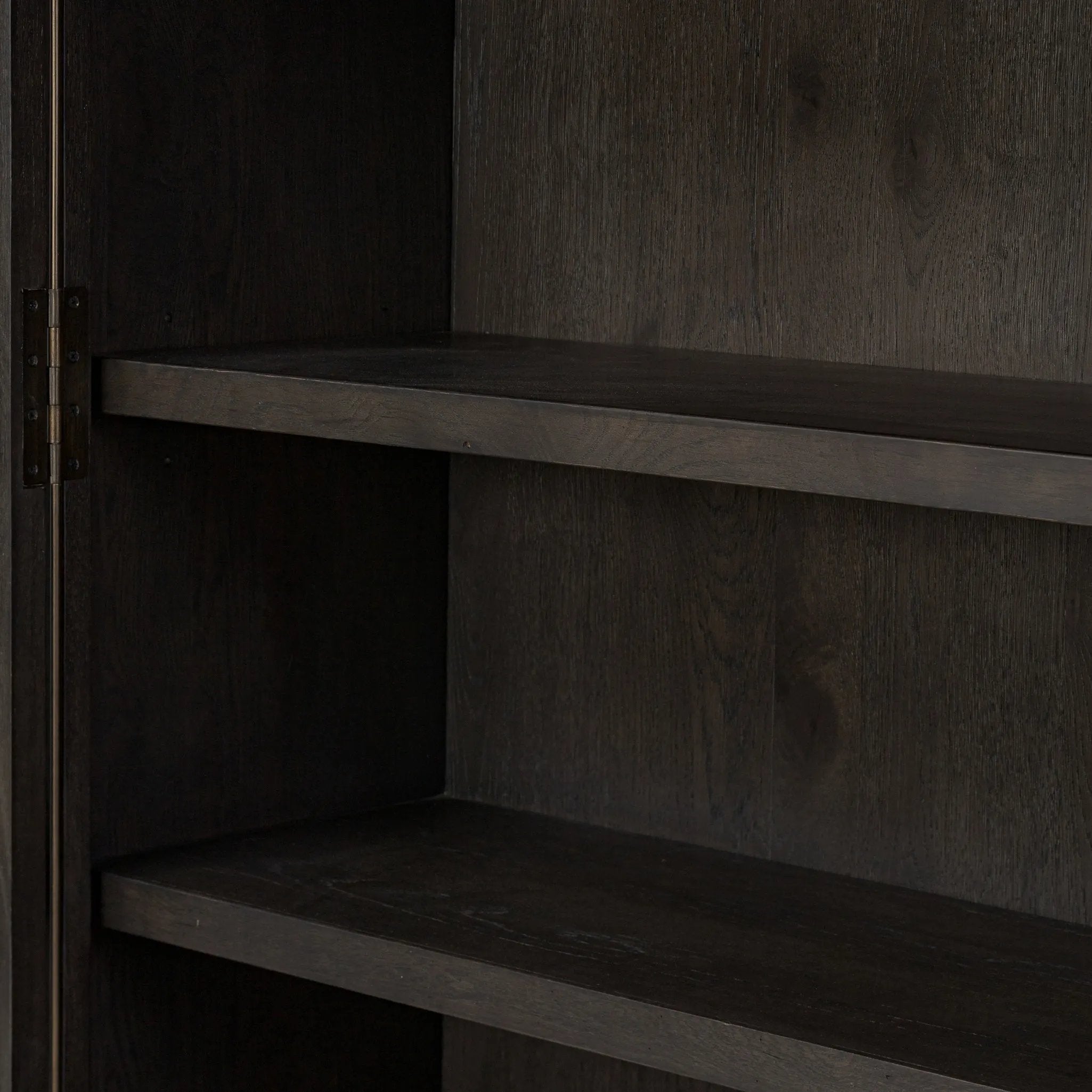 Featuring Dawes Smoked Black Oak Cabinet by Four Hands at Amethyst Home. Work the timeless charm of a vintage find into your collection. Smoked black oak cabinetry features softened mullions and rounded glass panels, with aged bronze barrel hinges and finial detailing. Generous storage and display options empower you to create a space that tells your story.Ove. Amethyst Home provides interior design, new home construction design consulting, vintage area rugs, and lighting in the Dallas metro area.