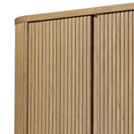 Crafted from light oak with a plinth-style base, rounded sides and linear reeding, this tall cabinet works subtle midcentury vibes into any space. Fully finished interior and shelves for quality detailing inside and out Amethyst Home provides interior design, new home construction design consulting, vintage area rugs, and lighting in the Charlotte metro area.