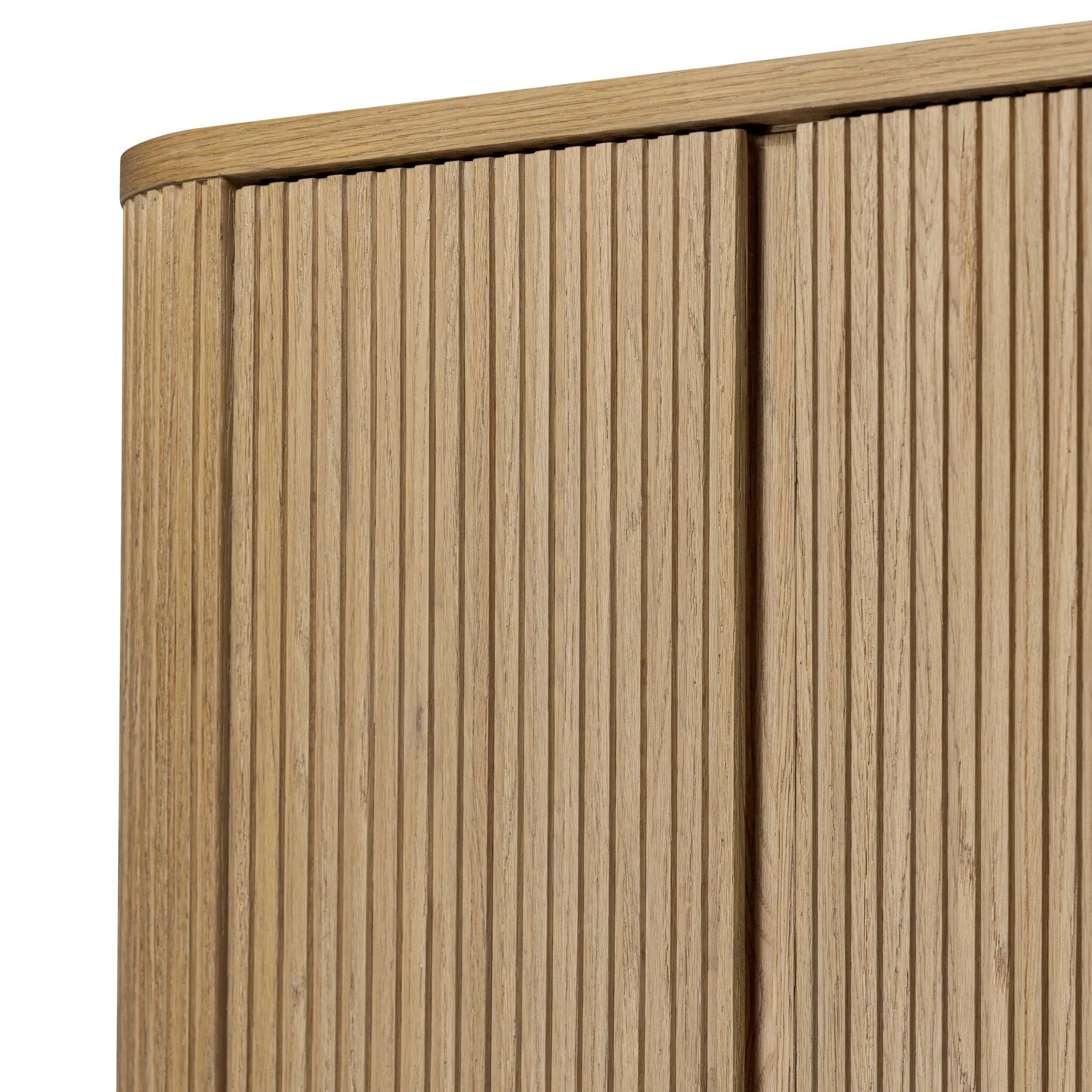 Crafted from light oak with a plinth-style base, rounded sides and linear reeding, this tall cabinet works subtle midcentury vibes into any space. Fully finished interior and shelves for quality detailing inside and out Amethyst Home provides interior design, new home construction design consulting, vintage area rugs, and lighting in the Charlotte metro area.