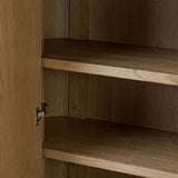 Crafted from light oak with a plinth-style base, rounded sides and linear reeding, this tall cabinet works subtle midcentury vibes into any space. Fully finished interior and shelves for quality detailing inside and out Amethyst Home provides interior design, new home construction design consulting, vintage area rugs, and lighting in the Houston metro area.