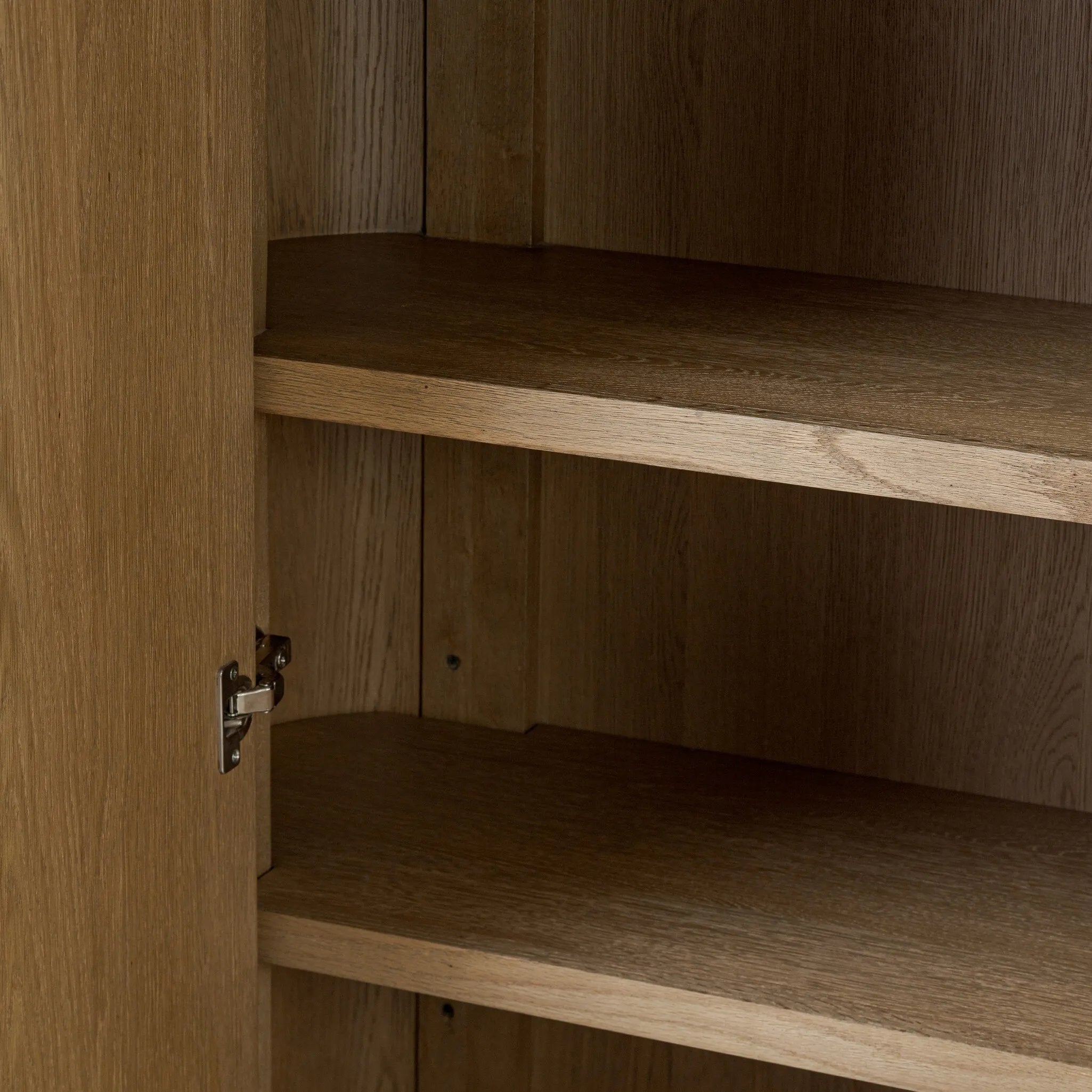 Crafted from light oak with a plinth-style base, rounded sides and linear reeding, this tall cabinet works subtle midcentury vibes into any space. Fully finished interior and shelves for quality detailing inside and out Amethyst Home provides interior design, new home construction design consulting, vintage area rugs, and lighting in the Houston metro area.
