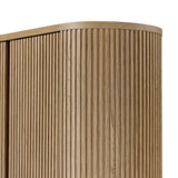 Crafted from light oak with a plinth-style base, rounded sides and linear reeding, this tall cabinet works subtle midcentury vibes into any space. Fully finished interior and shelves for quality detailing inside and out Amethyst Home provides interior design, new home construction design consulting, vintage area rugs, and lighting in the Park City metro area.