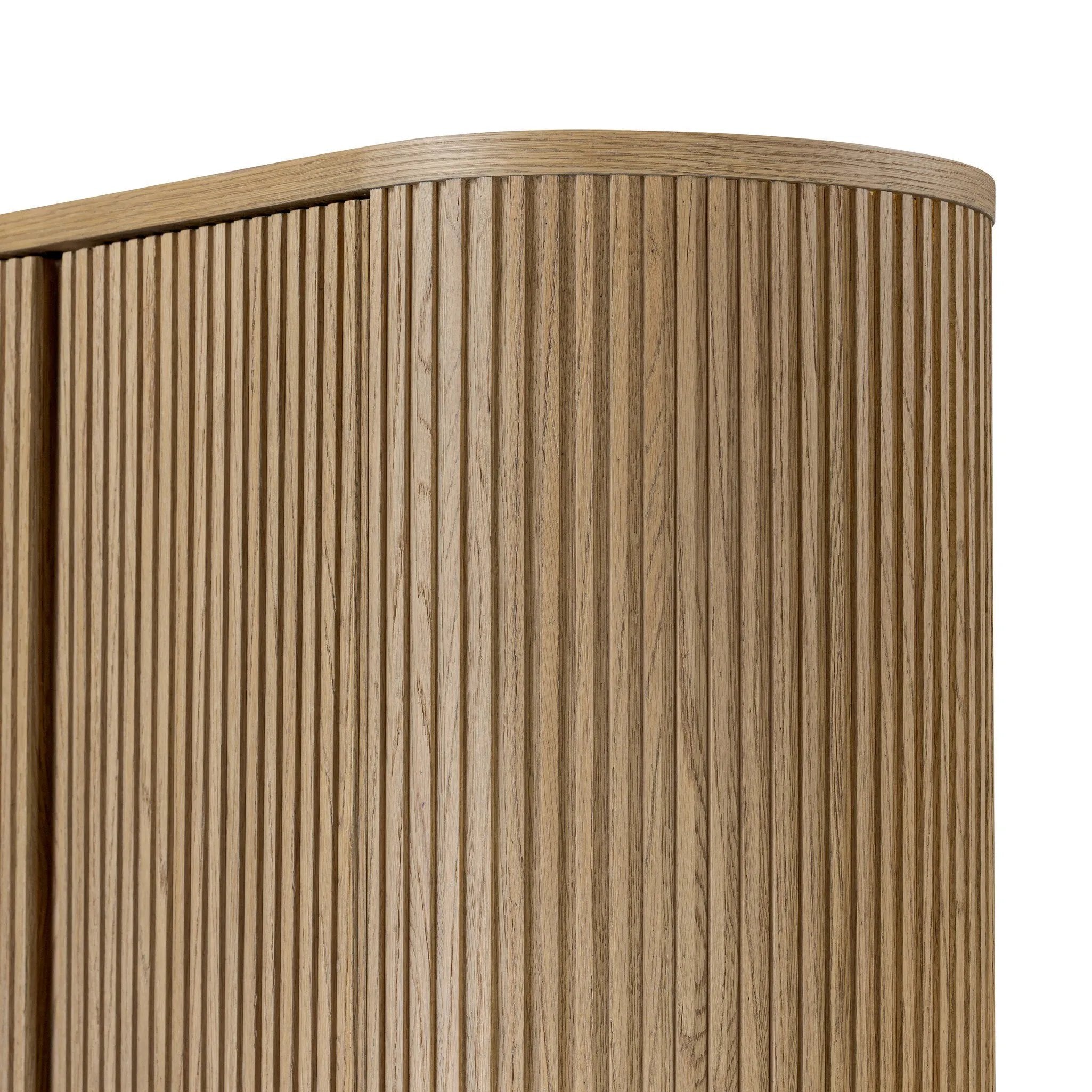 Crafted from light oak with a plinth-style base, rounded sides and linear reeding, this tall cabinet works subtle midcentury vibes into any space. Fully finished interior and shelves for quality detailing inside and out Amethyst Home provides interior design, new home construction design consulting, vintage area rugs, and lighting in the Park City metro area.