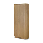 Crafted from light oak with a plinth-style base, rounded sides and linear reeding, this tall cabinet works subtle midcentury vibes into any space. Fully finished interior and shelves for quality detailing inside and out Amethyst Home provides interior design, new home construction design consulting, vintage area rugs, and lighting in the Salt Lake City metro area.