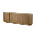 Crafted from desert oak solids and veneers with a plinth-style base, rounded sides and linear reeding, this sideboard exudes midcentury vibes.  Fully finished interior and shelves for quality detailing inside and out Amethyst Home provides interior design, new home construction design consulting, vintage area rugs, and lighting in the Alpharetta metro area.