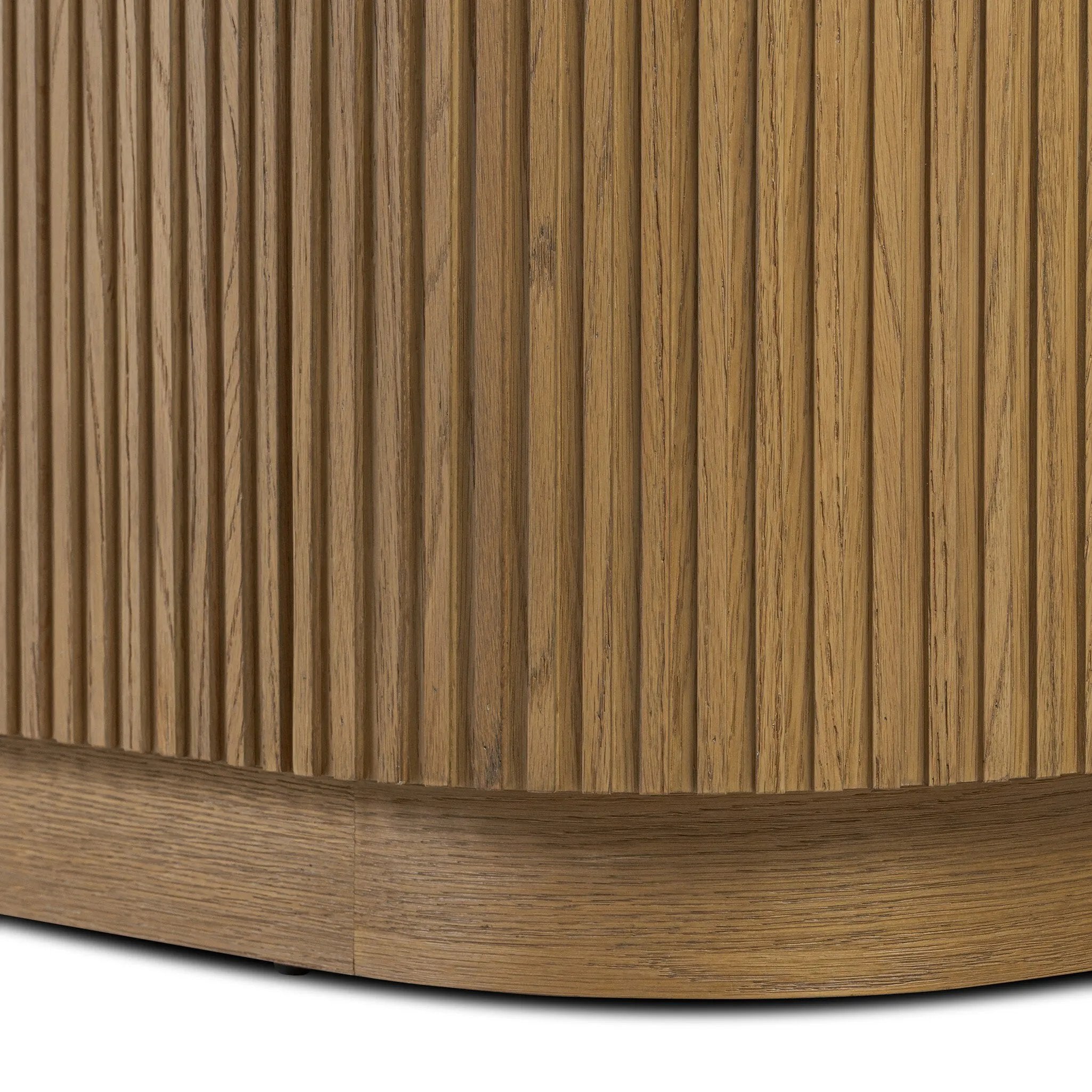 Crafted from desert oak solids and veneers with a plinth-style base, rounded sides and linear reeding, this sideboard exudes midcentury vibes.  Fully finished interior and shelves for quality detailing inside and out Amethyst Home provides interior design, new home construction design consulting, vintage area rugs, and lighting in the Kansas City metro area.