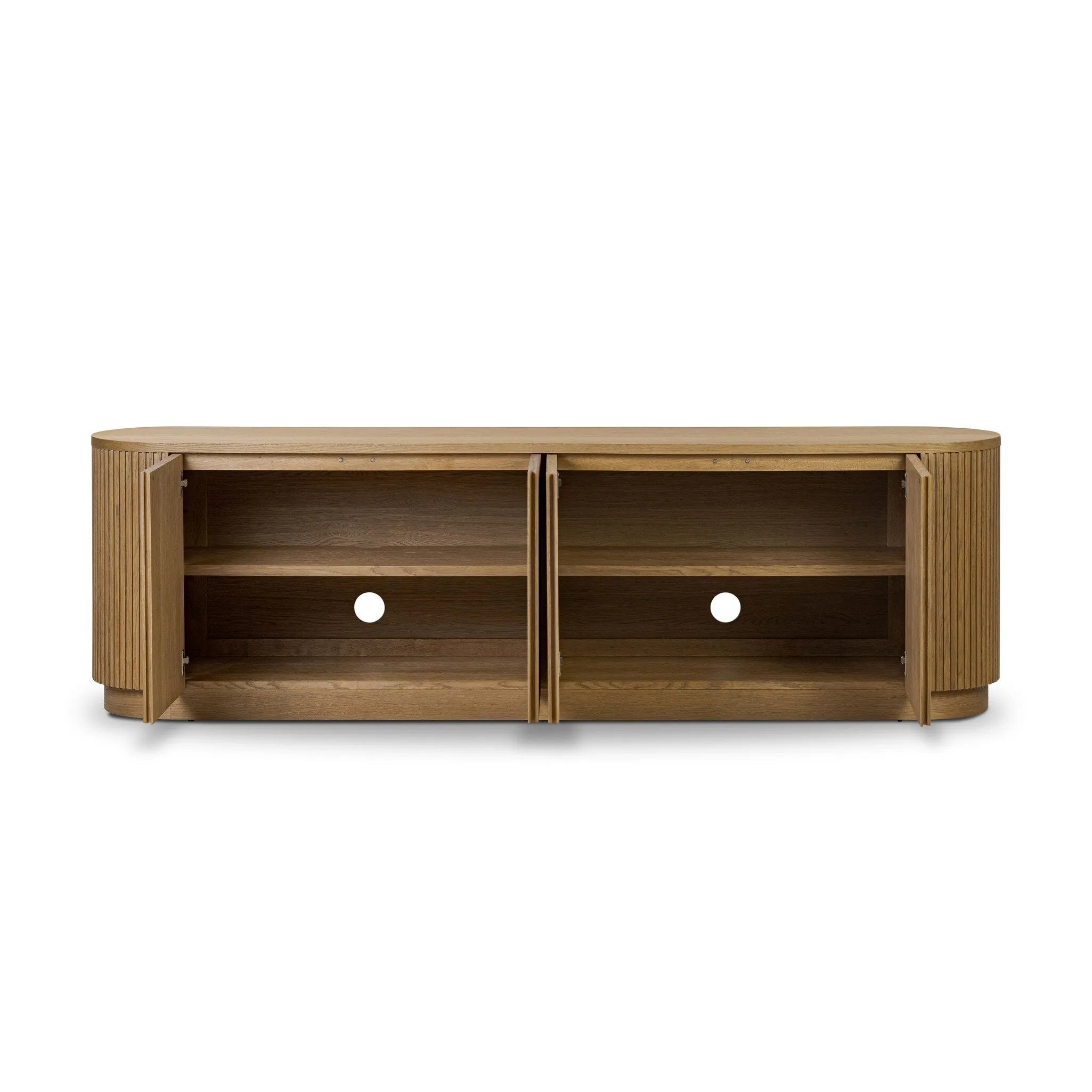 Crafted from desert oak solids and veneers with a plinth-style base, rounded sides and linear reeding, this sideboard exudes midcentury vibes.  Fully finished interior and shelves for quality detailing inside and out Amethyst Home provides interior design, new home construction design consulting, vintage area rugs, and lighting in the Los Angeles metro area.