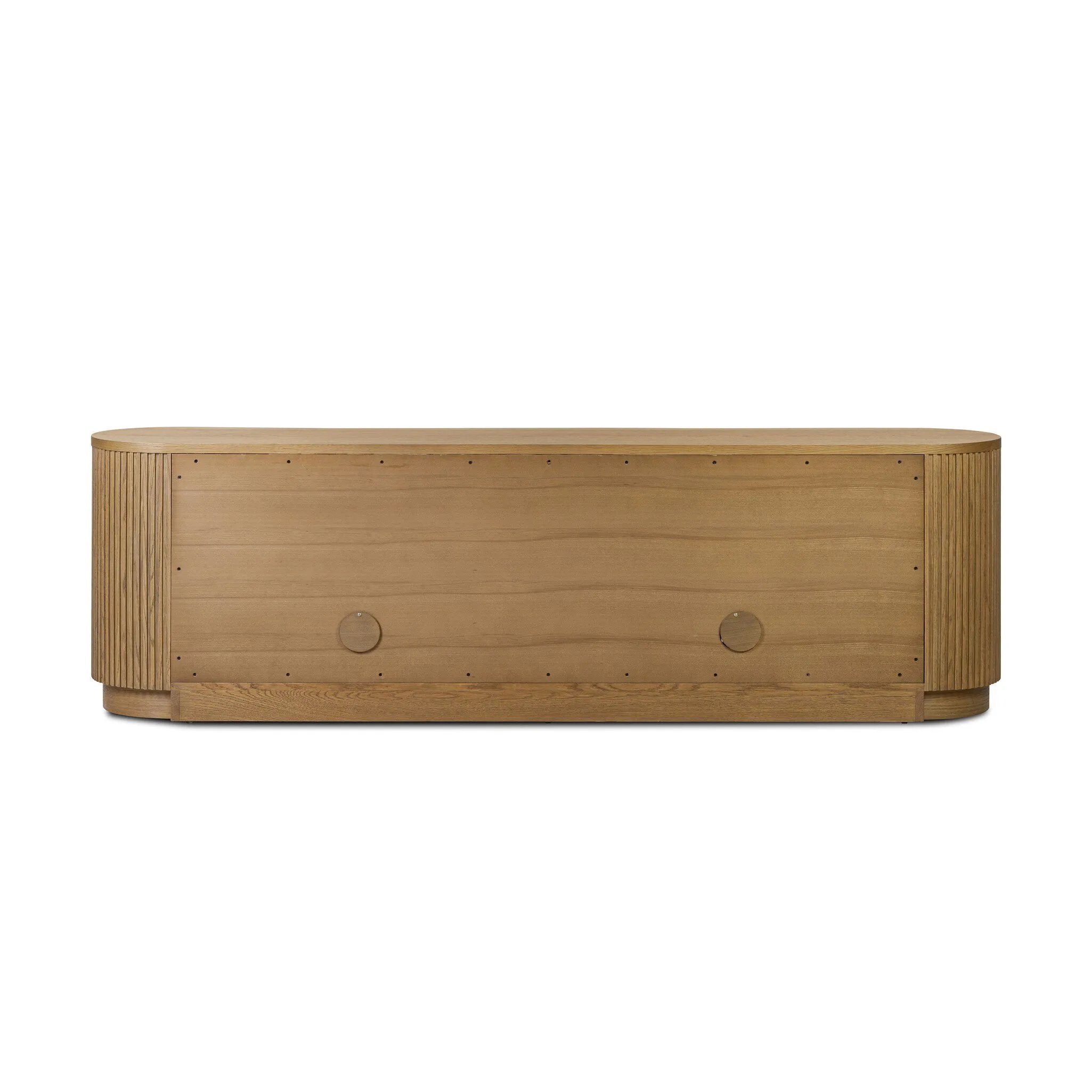 Crafted from desert oak solids and veneers with a plinth-style base, rounded sides and linear reeding, this sideboard exudes midcentury vibes.  Fully finished interior and shelves for quality detailing inside and out Amethyst Home provides interior design, new home construction design consulting, vintage area rugs, and lighting in the Monterey metro area.