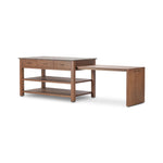 A kitchen island and waterfall dining table in one. Crafted from oak, the island system features two large shelves and three drawers on each side, all  topped with by warm grey marble. The pullout table extends and fits inside the frame with ease Amethyst Home provides interior design, new home construction design consulting, vintage area rugs, and lighting in the Charlotte metro area.