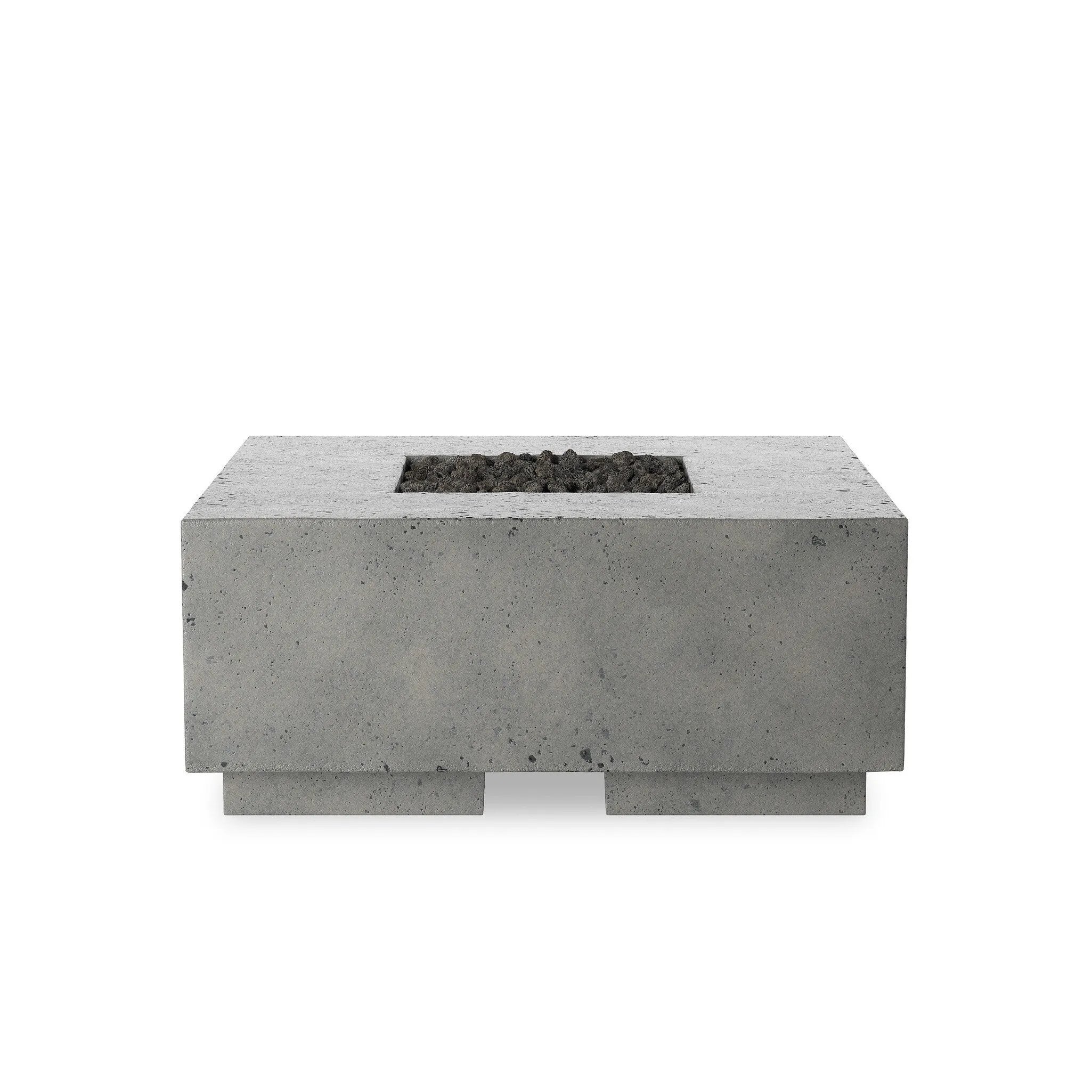 This outdoor fire table is a welcoming centerpiece designed for gathering. Made from glass-reinforced concrete, each piece is naturally finished with deep tones of pewter and dark grey. The monolithic shape is completed with lavastones in the center, bringing together a bold, monochromatic look. Amethyst Home provides interior design, new home construction design consulting, vintage area rugs, and lighting in the Alpharetta metro area.