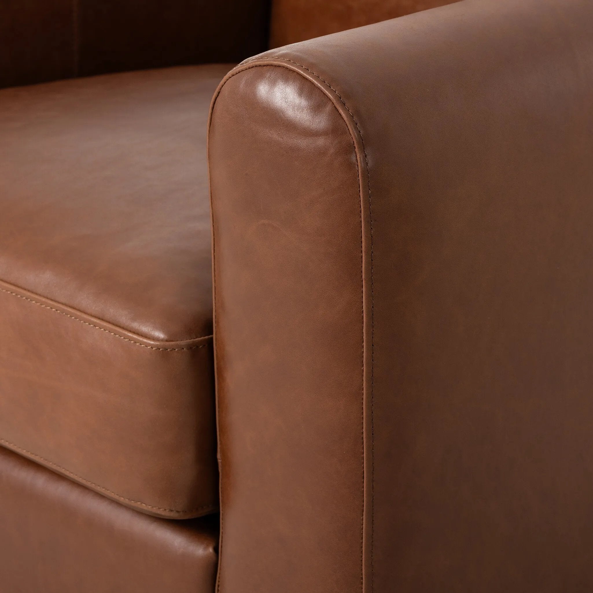 The popular Art Deco club chair makes a comeback. With a prominent curved top, deep seat with a loose cushion, and armrests designed for true relaxation, the armchair invites you to sit back and take it all in. Upholstered in rich mahogany top-grain leather. Amethyst Home provides interior design, new home construction design consulting, vintage area rugs, and lighting in the Seattle metro area.