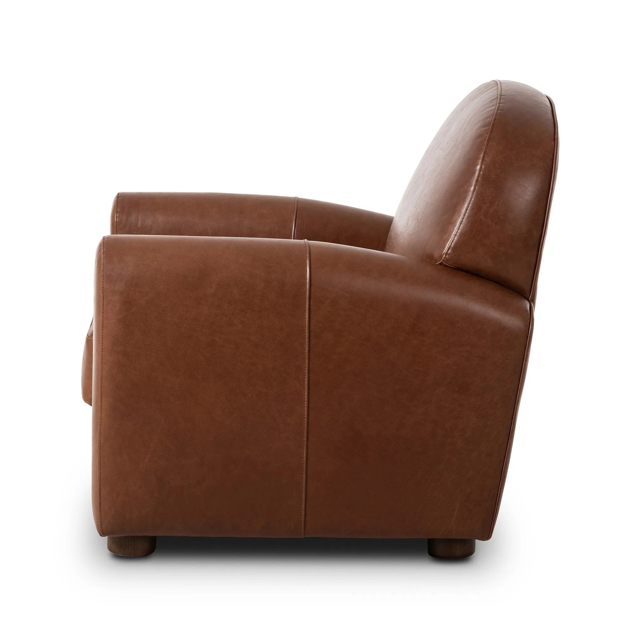 The popular Art Deco club chair makes a comeback. With a prominent curved top, deep seat with a loose cushion, and armrests designed for true relaxation, the armchair invites you to sit back and take it all in. Upholstered in rich mahogany top-grain leather. Amethyst Home provides interior design, new home construction design consulting, vintage area rugs, and lighting in the Tampa metro area.