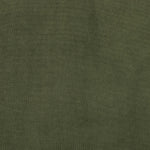 A low, spacious mid-century silhouette is covered in velvety upholstery in an intriguing sapphire olive, with blind tufting Amethyst Home provides interior design, new home construction design consulting, vintage area rugs, and lighting in the Kansas City metro area.