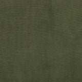 A low, spacious mid-century silhouette is covered in velvety upholstery in an intriguing sapphire olive, with blind tufting Amethyst Home provides interior design, new home construction design consulting, vintage area rugs, and lighting in the Kansas City metro area.