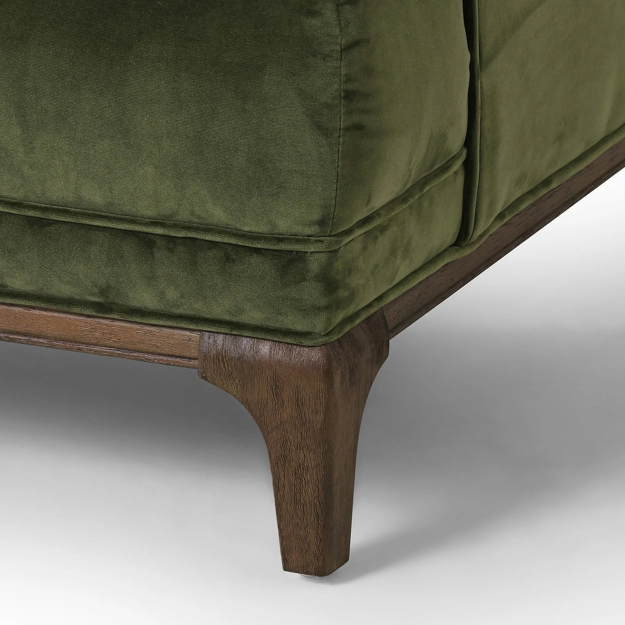 A low, spacious mid-century silhouette is covered in velvety upholstery in an intriguing sapphire olive, with blind tufting Amethyst Home provides interior design, new home construction design consulting, vintage area rugs, and lighting in the Newport Beach metro area.