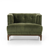 A low, spacious mid-century silhouette is covered in velvety upholstery in an intriguing sapphire olive, with blind tufting Amethyst Home provides interior design, new home construction design consulting, vintage area rugs, and lighting in the Tampa metro area.