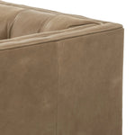 A modernized midcentury silhouette meets the traditional Chesterfield sofa, all in a compact profile perfect for smaller spaces. Top-grain leather in a tan hue, button tufting and a smooth touch bring deep comfort to lounging Amethyst Home provides interior design, new home construction design consulting, vintage area rugs, and lighting in the Boston metro area.