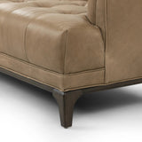 A modernized midcentury silhouette meets the traditional Chesterfield sofa, all in a compact profile perfect for smaller spaces. Top-grain leather in a tan hue, button tufting and a smooth touch bring deep comfort to lounging Amethyst Home provides interior design, new home construction design consulting, vintage area rugs, and lighting in the Laguna Beach metro area.