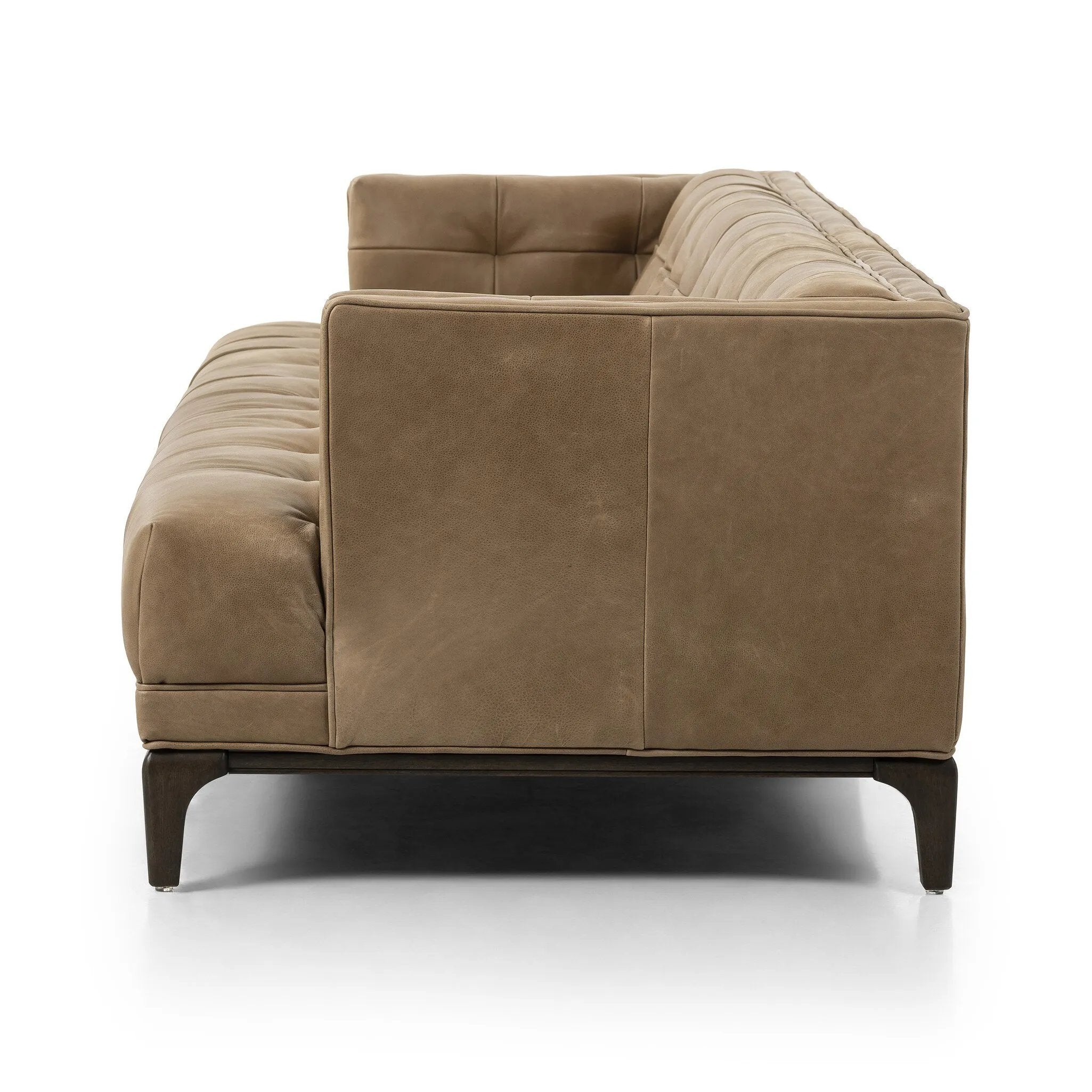 A modernized midcentury silhouette meets the traditional Chesterfield sofa, all in a compact profile perfect for smaller spaces. Top-grain leather in a tan hue, button tufting and a smooth touch bring deep comfort to lounging Amethyst Home provides interior design, new home construction design consulting, vintage area rugs, and lighting in the Omaha metro area.
