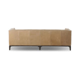 A modernized midcentury silhouette meets the traditional Chesterfield sofa, all in a compact profile perfect for smaller spaces. Top-grain leather in a tan hue, button tufting and a smooth touch bring deep comfort to lounging Amethyst Home provides interior design, new home construction design consulting, vintage area rugs, and lighting in the Park City metro area.