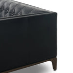 A modernized midcentury silhouette meets the traditional Chesterfield sofa, all in a compact profile perfect for smaller spaces. Top-grain leather in a classic black, button tufting and a smooth touch bring deep comfort to lounging Amethyst Home provides interior design, new home construction design consulting, vintage area rugs, and lighting in the Calabasas metro area.