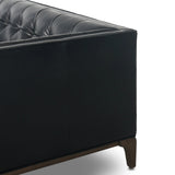 A modernized midcentury silhouette meets the traditional Chesterfield sofa, all in a compact profile perfect for smaller spaces. Top-grain leather in a classic black, button tufting and a smooth touch bring deep comfort to lounging Amethyst Home provides interior design, new home construction design consulting, vintage area rugs, and lighting in the Calabasas metro area.
