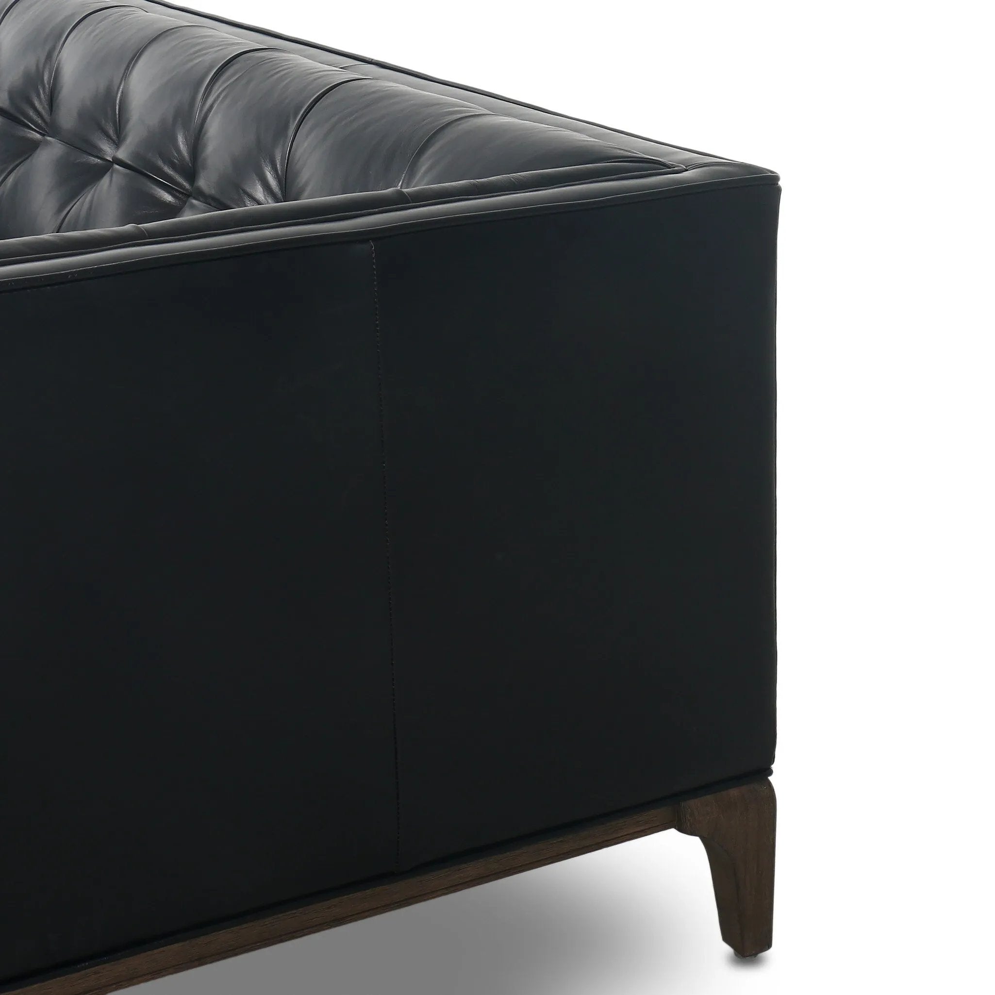 A modernized midcentury silhouette meets the traditional Chesterfield sofa, all in a compact profile perfect for smaller spaces. Top-grain leather in a classic black, button tufting and a smooth touch bring deep comfort to lounging Amethyst Home provides interior design, new home construction design consulting, vintage area rugs, and lighting in the Calabasas metro area.