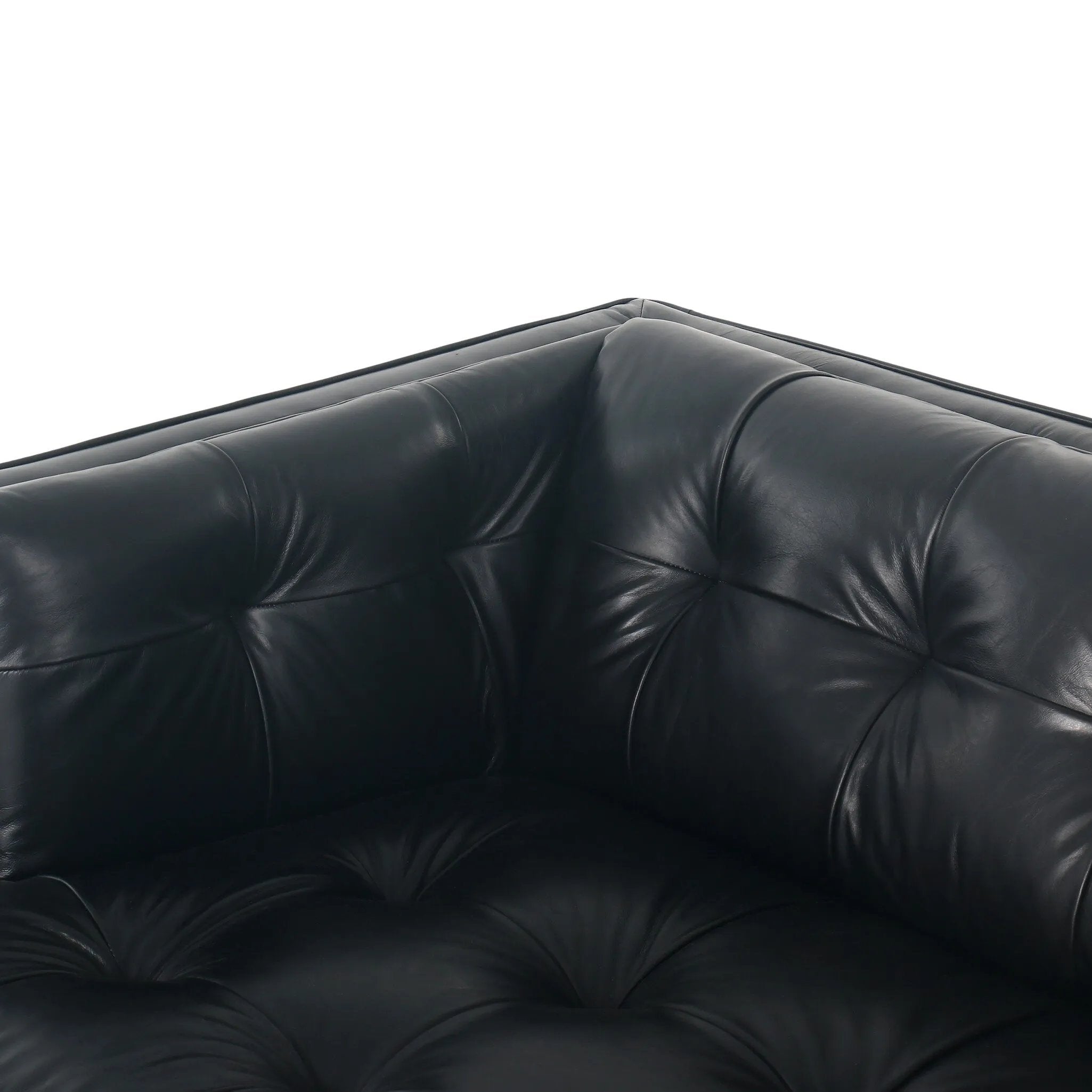 A modernized midcentury silhouette meets the traditional Chesterfield sofa, all in a compact profile perfect for smaller spaces. Top-grain leather in a classic black, button tufting and a smooth touch bring deep comfort to lounging Amethyst Home provides interior design, new home construction design consulting, vintage area rugs, and lighting in the Charlotte metro area.