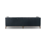 A modernized midcentury silhouette meets the traditional Chesterfield sofa, all in a compact profile perfect for smaller spaces. Top-grain leather in a classic black, button tufting and a smooth touch bring deep comfort to lounging Amethyst Home provides interior design, new home construction design consulting, vintage area rugs, and lighting in the Dallas metro area.