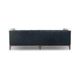 A modernized midcentury silhouette meets the traditional Chesterfield sofa, all in a compact profile perfect for smaller spaces. Top-grain leather in a classic black, button tufting and a smooth touch bring deep comfort to lounging Amethyst Home provides interior design, new home construction design consulting, vintage area rugs, and lighting in the Dallas metro area.