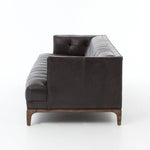 A modernized midcentury silhouette meets the traditional Chesterfield sofa, all in a compact profile perfect for smaller spaces. Top-grain leather in a classic black, button tufting and a smooth touch bring deep comfort to lounging Amethyst Home provides interior design, new home construction design consulting, vintage area rugs, and lighting in the Kansas City metro area.