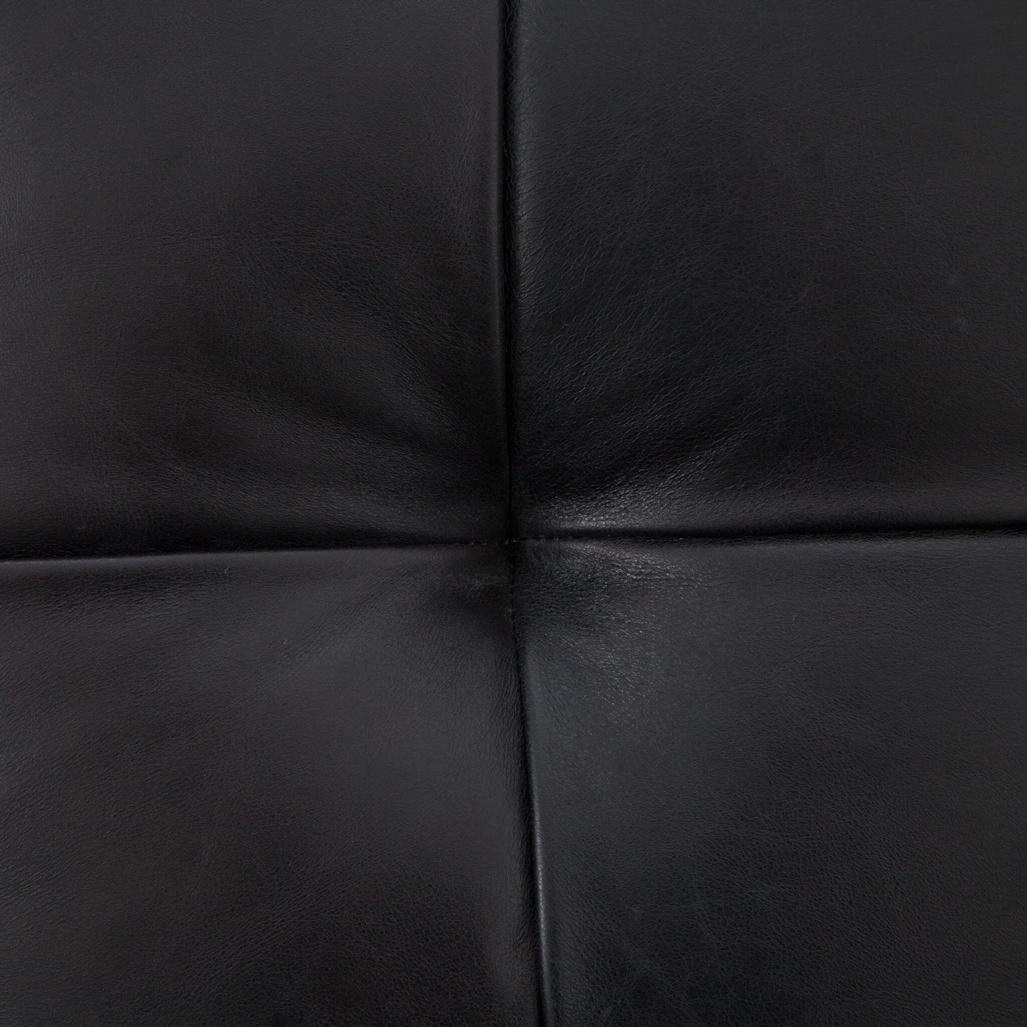 A modernized midcentury silhouette meets the traditional Chesterfield sofa, all in a compact profile perfect for smaller spaces. Top-grain leather in a classic black, button tufting and a smooth touch bring deep comfort to lounging Amethyst Home provides interior design, new home construction design consulting, vintage area rugs, and lighting in the Salt Lake City metro area.