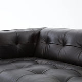 A modernized midcentury silhouette meets the traditional Chesterfield sofa, all in a compact profile perfect for smaller spaces. Top-grain leather in a classic black, button tufting and a smooth touch bring deep comfort to lounging Amethyst Home provides interior design, new home construction design consulting, vintage area rugs, and lighting in the Winter Garden metro area.