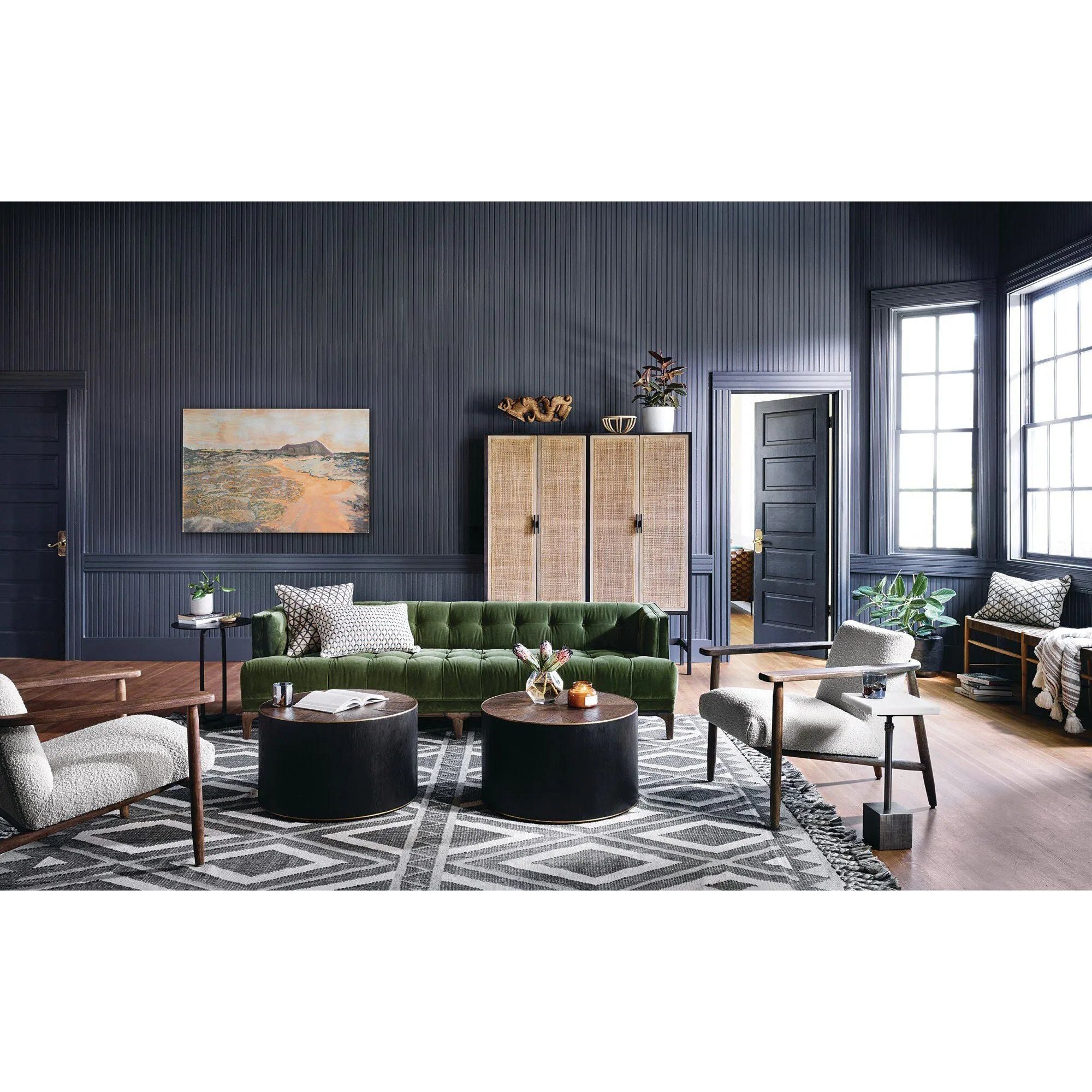 A modernized midcentury silhouette meets the traditional Chesterfield sofa, all in a compact profile perfect for smaller spaces. Smooth velvet in an olive hue, button tufting and a soft touch bring deep comfort to lounging Amethyst Home provides interior design, new home construction design consulting, vintage area rugs, and lighting in the Charlotte metro area.