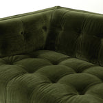A modernized midcentury silhouette meets the traditional Chesterfield sofa, all in a compact profile perfect for smaller spaces. Smooth velvet in an olive hue, button tufting and a soft touch bring deep comfort to lounging Amethyst Home provides interior design, new home construction design consulting, vintage area rugs, and lighting in the Houston metro area.