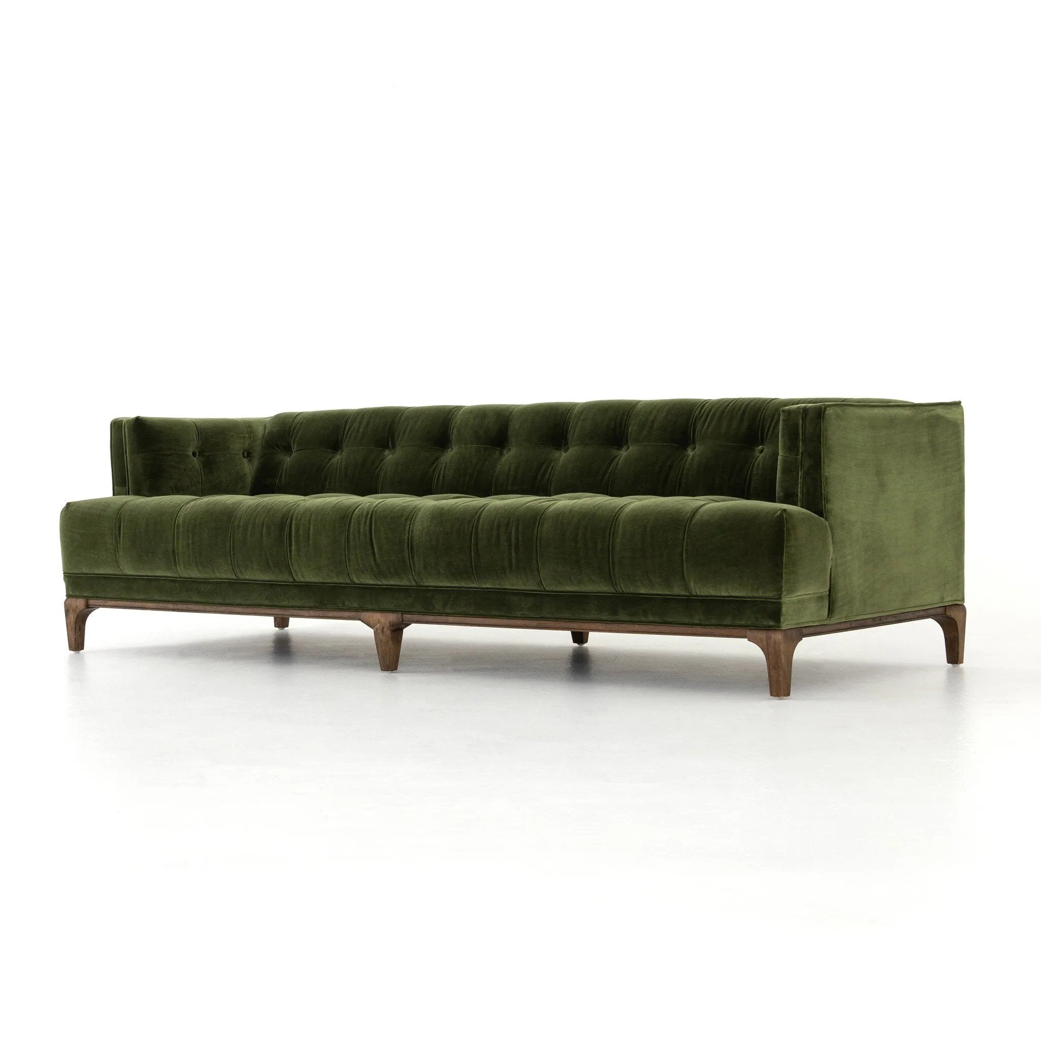 A modernized midcentury silhouette meets the traditional Chesterfield sofa, all in a compact profile perfect for smaller spaces. Smooth velvet in an olive hue, button tufting and a soft touch bring deep comfort to lounging Amethyst Home provides interior design, new home construction design consulting, vintage area rugs, and lighting in the Los Angeles metro area.