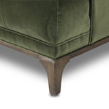 A modernized midcentury silhouette meets the traditional Chesterfield sofa, all in a compact profile perfect for smaller spaces. Smooth velvet in an olive hue, button tufting and a soft touch bring deep comfort to lounging Amethyst Home provides interior design, new home construction design consulting, vintage area rugs, and lighting in the Omaha metro area.