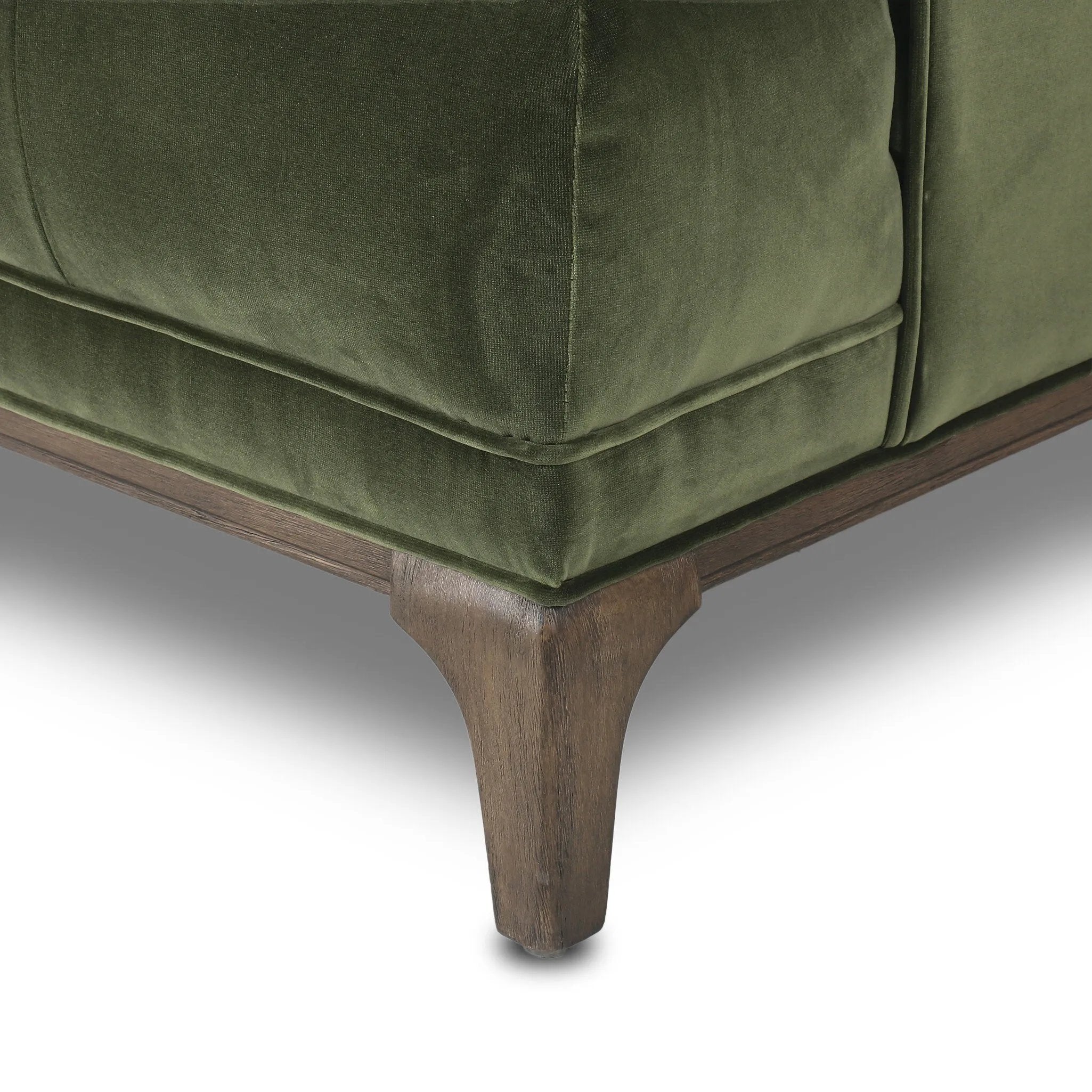 A modernized midcentury silhouette meets the traditional Chesterfield sofa, all in a compact profile perfect for smaller spaces. Smooth velvet in an olive hue, button tufting and a soft touch bring deep comfort to lounging Amethyst Home provides interior design, new home construction design consulting, vintage area rugs, and lighting in the Omaha metro area.