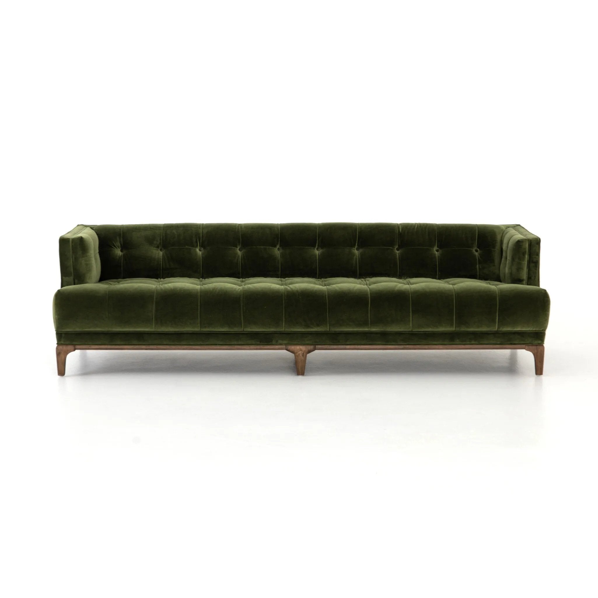 A modernized midcentury silhouette meets the traditional Chesterfield sofa, all in a compact profile perfect for smaller spaces. Smooth velvet in an olive hue, button tufting and a soft touch bring deep comfort to lounging Amethyst Home provides interior design, new home construction design consulting, vintage area rugs, and lighting in the Park City metro area.