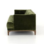 A modernized midcentury silhouette meets the traditional Chesterfield sofa, all in a compact profile perfect for smaller spaces. Smooth velvet in an olive hue, button tufting and a soft touch bring deep comfort to lounging Amethyst Home provides interior design, new home construction design consulting, vintage area rugs, and lighting in the Portland metro area.