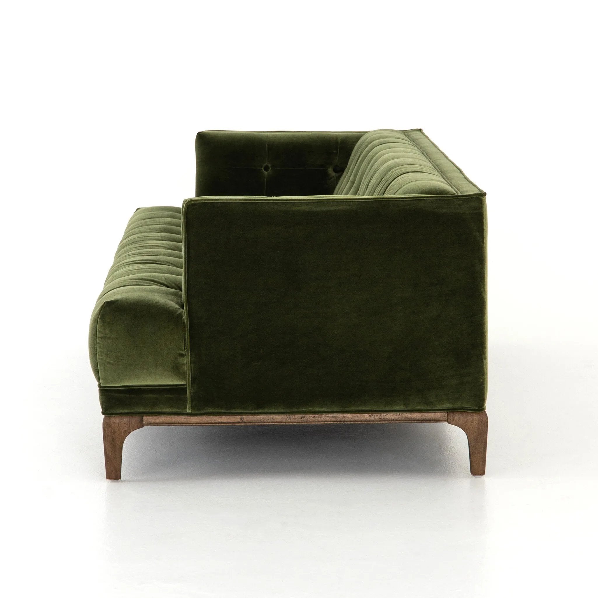 A modernized midcentury silhouette meets the traditional Chesterfield sofa, all in a compact profile perfect for smaller spaces. Smooth velvet in an olive hue, button tufting and a soft touch bring deep comfort to lounging Amethyst Home provides interior design, new home construction design consulting, vintage area rugs, and lighting in the Portland metro area.