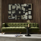 A modernized midcentury silhouette meets the traditional Chesterfield sofa, all in a compact profile perfect for smaller spaces. Smooth velvet in an olive hue, button tufting and a soft touch bring deep comfort to lounging Amethyst Home provides interior design, new home construction design consulting, vintage area rugs, and lighting in the Washington metro area.