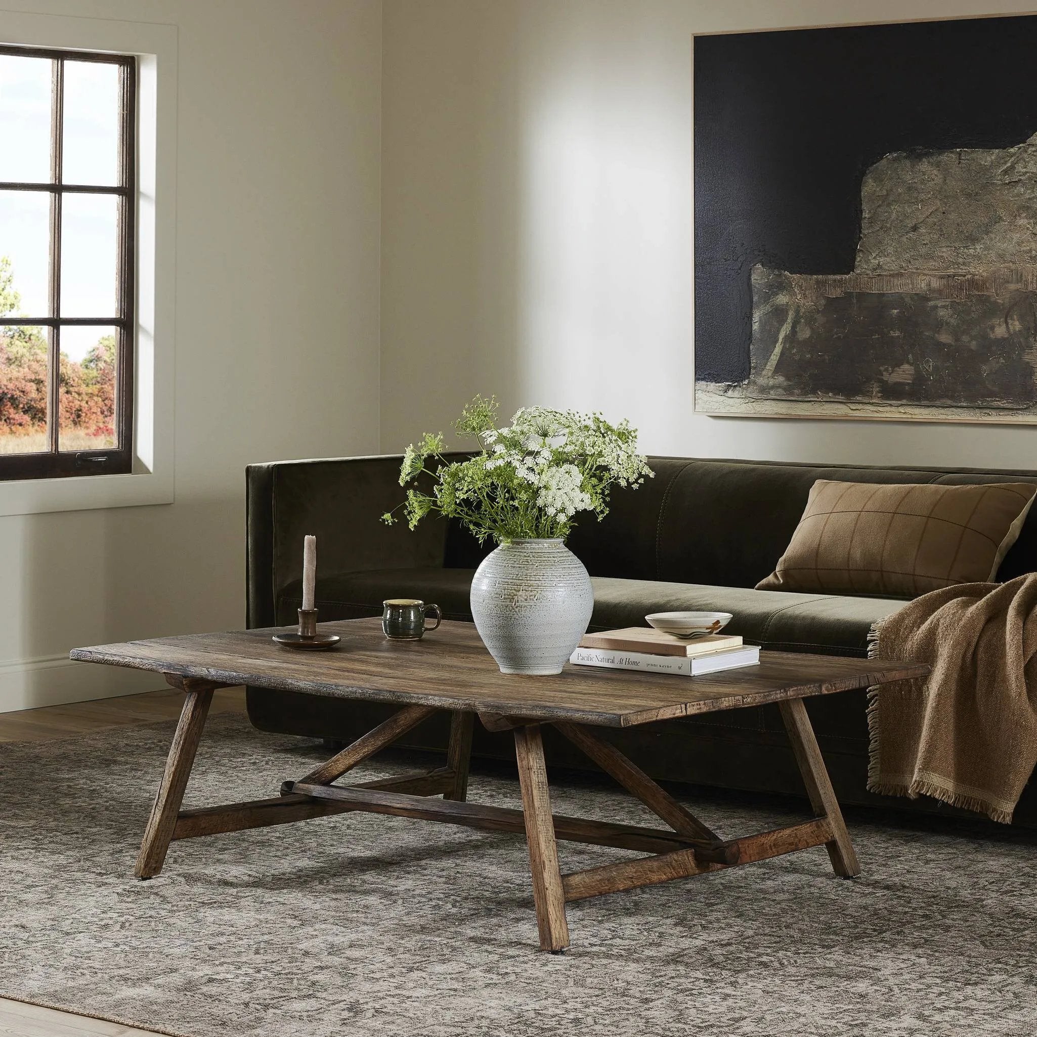 Center your living space with a Wabi Sabi-inspired coffee table. Crafted from burnt bleached oak with a trellis base and wide plank top, this artisanal piece embraces the natural cracks and graining reflective of organic materials to bring a beautiful, character-rich look to your space Amethyst Home provides interior design, new home construction design consulting, vintage area rugs, and lighting in the Miami metro area.