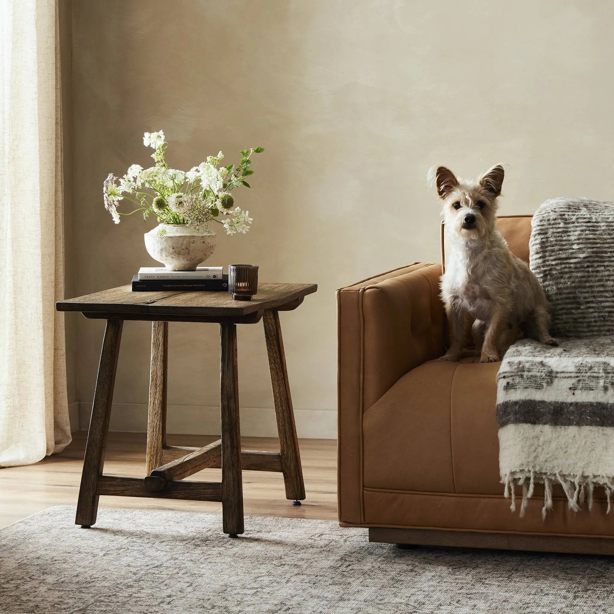 Accent your living space with a Wabi Sabi-inspired end table. Crafted from burnt bleached oak with a trellis base and wide plank top, this artisanal piece embraces the natural cracks and graining reflective of organic materials to bring a beautiful, character-rich look to your space Amethyst Home provides interior design, new home construction design consulting, vintage area rugs, and lighting in the Newport Beach metro area.