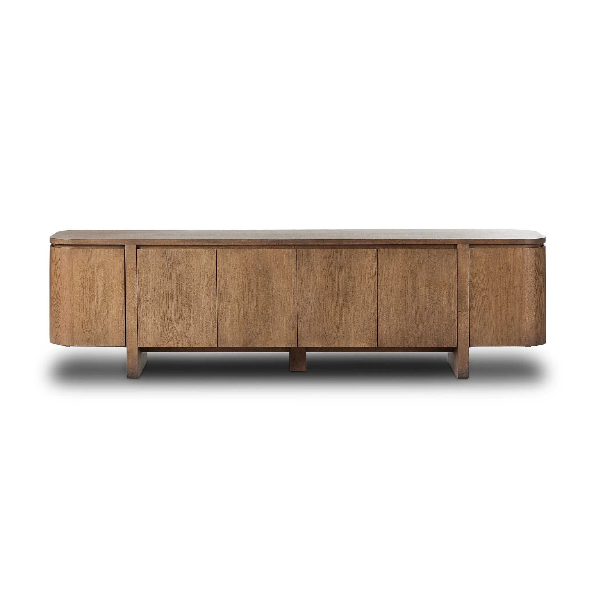 A clean-styled media console made from warm, grain-rich oak. Six doors feature subtle finger grooves for easy open. Gentle curves soften up the look, while a floating design keeps things feeling light and fresh. Inside, generous shelving awaits storage of media and more. Amethyst Home provides interior design, new home construction design consulting, vintage area rugs, and lighting in the Salt Lake City metro area.