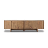 A clean-styled media console made from warm, grain-rich oak. Six doors feature subtle finger grooves for easy open. Gentle curves soften up the look, while a floating design keeps things feeling light and fresh. Inside, generous shelving awaits storage of media and more. Amethyst Home provides interior design, new home construction design consulting, vintage area rugs, and lighting in the Scottsdale metro area.