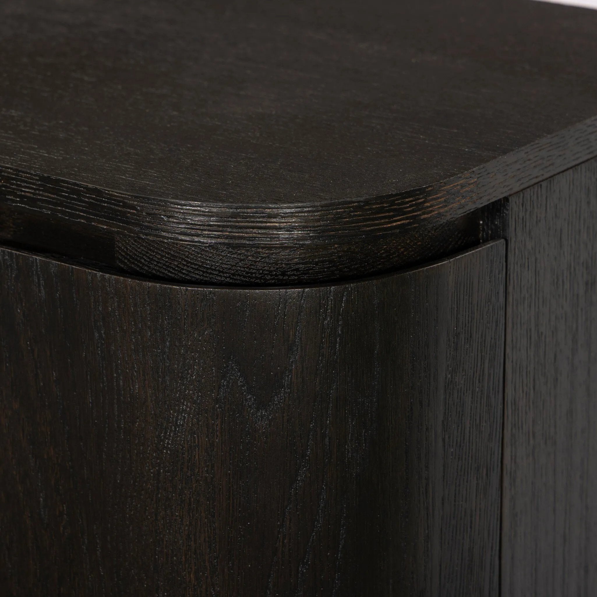 A clean-styled media console made from worn black oak. Six doors feature subtle finger grooves for easy open. Gentle curves soften up the look, while a floating design keeps things feeling light and fresh. Inside, generous shelving awaits storage of media and more. Amethyst Home provides interior design, new home construction design consulting, vintage area rugs, and lighting in the Alpharetta metro area.
