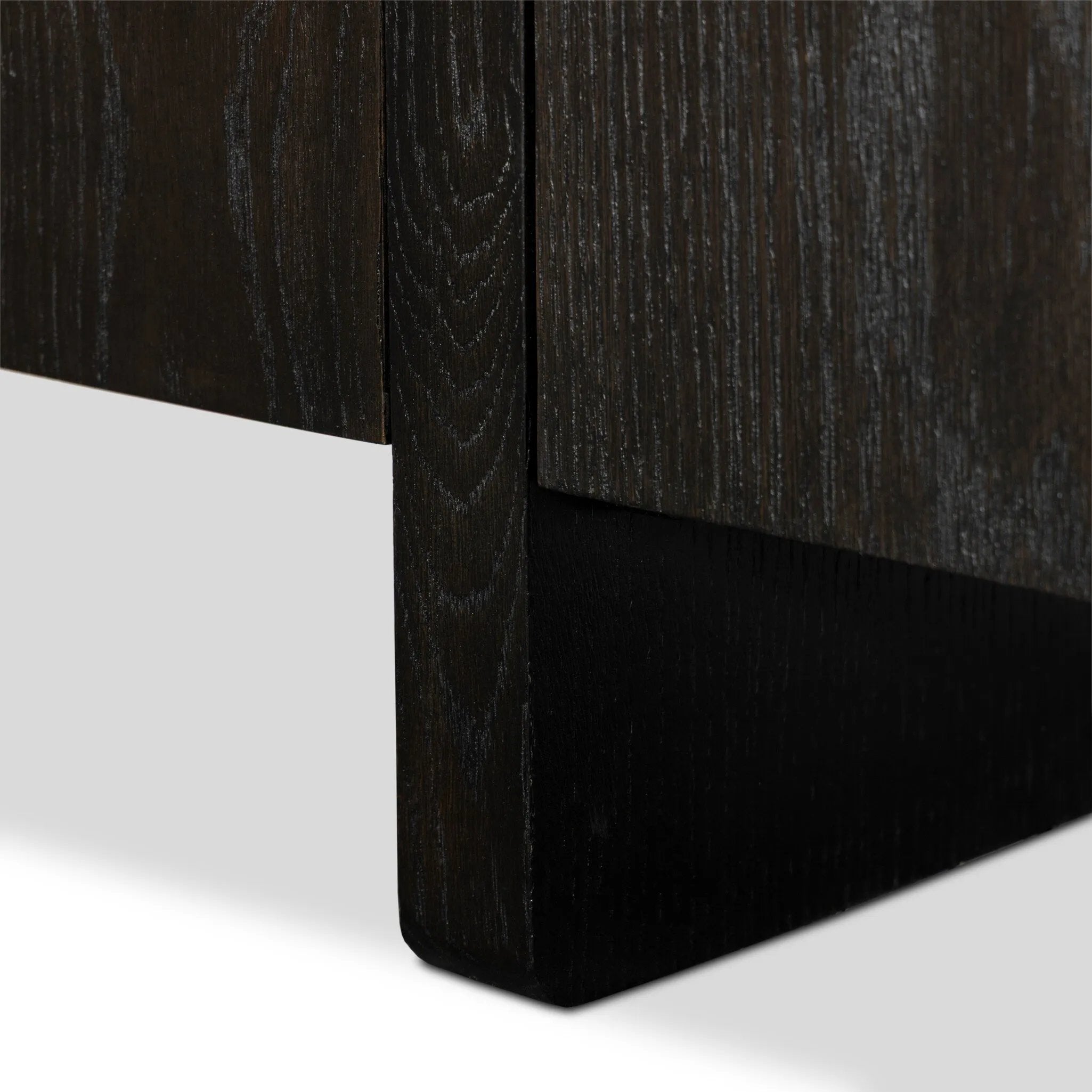 A clean-styled media console made from worn black oak. Six doors feature subtle finger grooves for easy open. Gentle curves soften up the look, while a floating design keeps things feeling light and fresh. Inside, generous shelving awaits storage of media and more. Amethyst Home provides interior design, new home construction design consulting, vintage area rugs, and lighting in the Miami metro area.