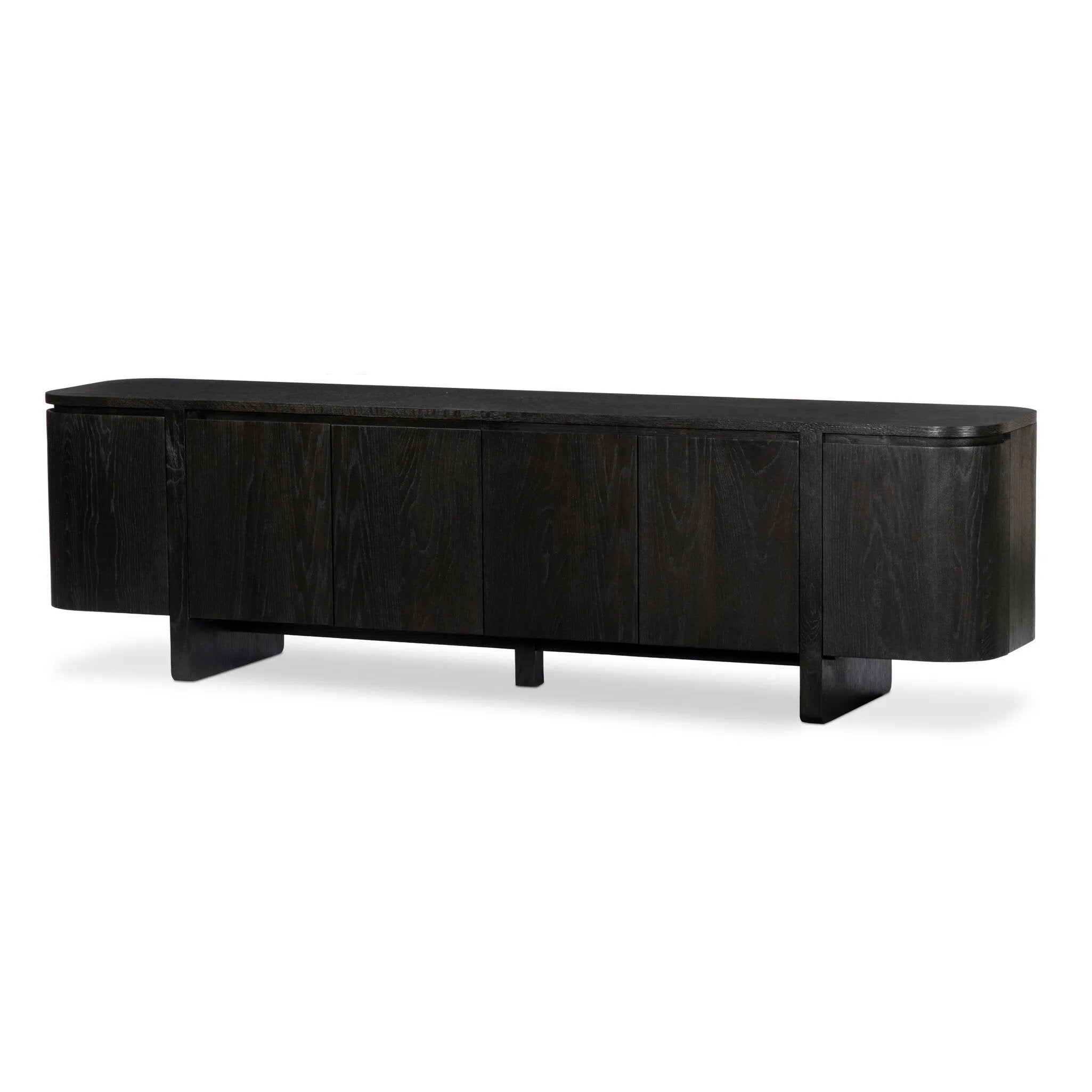 A clean-styled media console made from worn black oak. Six doors feature subtle finger grooves for easy open. Gentle curves soften up the look, while a floating design keeps things feeling light and fresh. Inside, generous shelving awaits storage of media and more. Amethyst Home provides interior design, new home construction design consulting, vintage area rugs, and lighting in the Portland metro area.